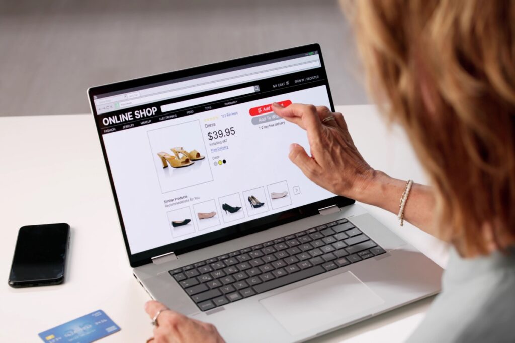 A woman purchases a pair of high heels on her laptop.