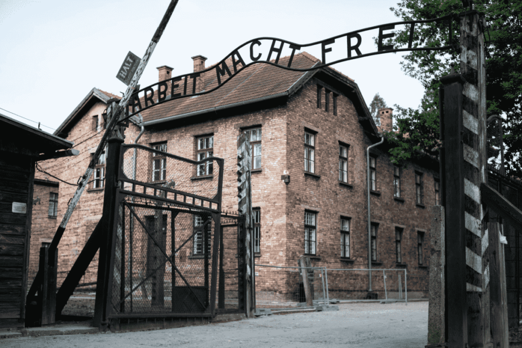 The main gate to the concentration camp Auschwitz-Birkenau, showing the inscription “Arbeit macht frei” and officials’ buildings. 