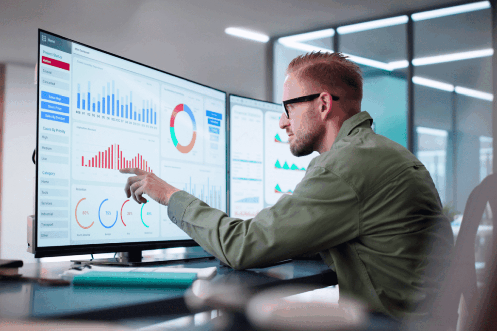 An analytics professional reviews data on a dashboard. 